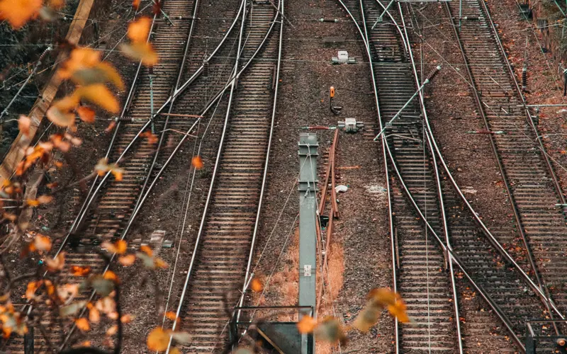 A view of multiple crisscrossing train tracks from above.