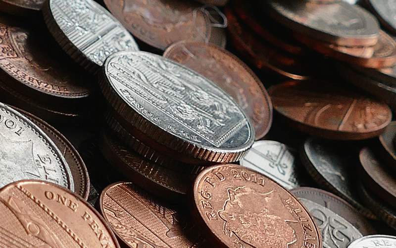 A pile of different British coins