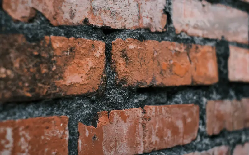 Close up photo of a brown brick wall