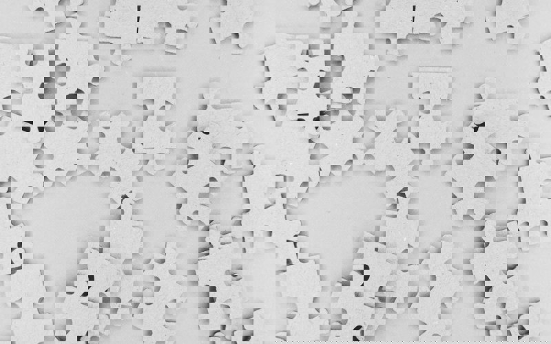 Plain jigsaw puzzle pieces viewed from above
