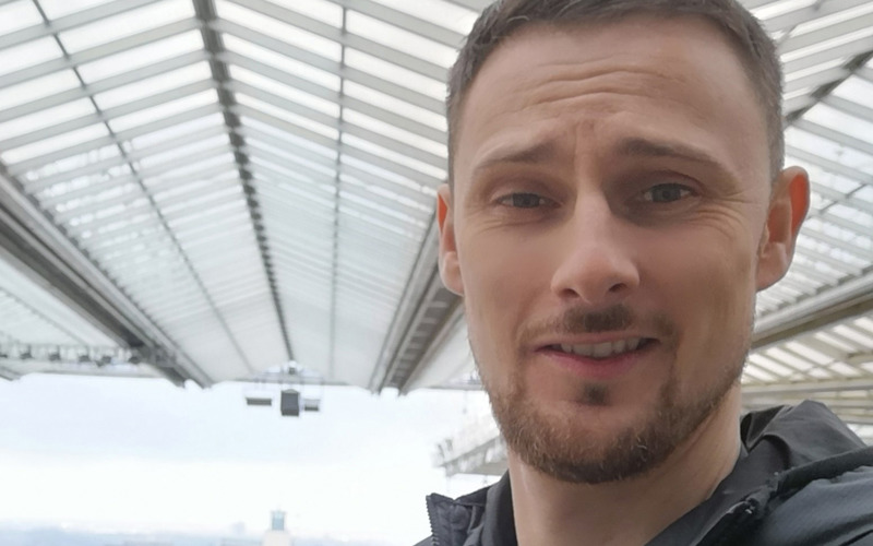 Casual headshot of David Jack in the upper levels of a stadium.