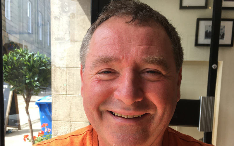 Casual headshot of Neil Rawlins sitting in a cafe