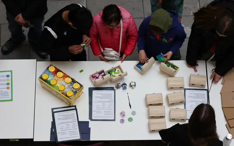 Children listen to an explanation of a lego based activity 