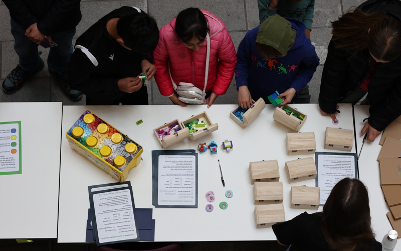 Children listen to an explanation of a lego based activity 