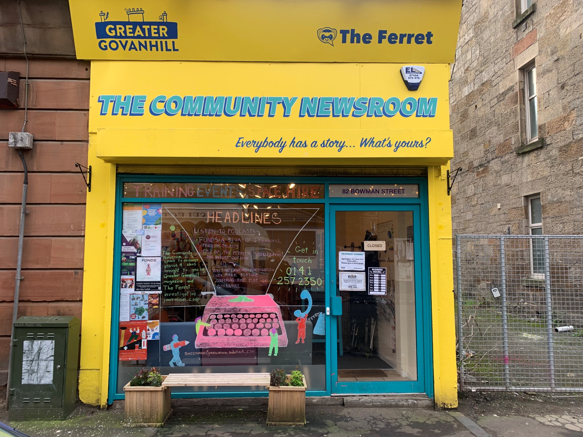 Photo of the Greater Govanhill Magazine newsroom building, painted bright yellow