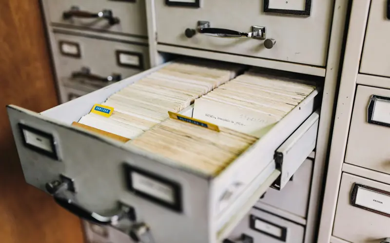 A white filing cabinet with an open drawer
