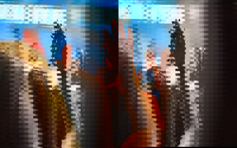 A person raising their hand