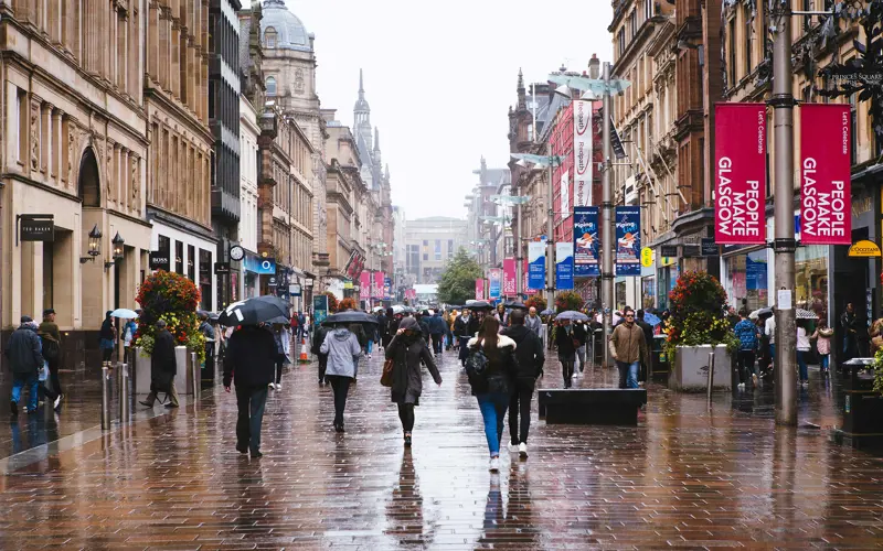 People walking on Buchanan Street in Glasgow in the rain.
