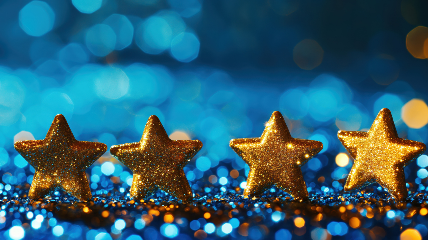 Four gold stars in a row with blue glittery background